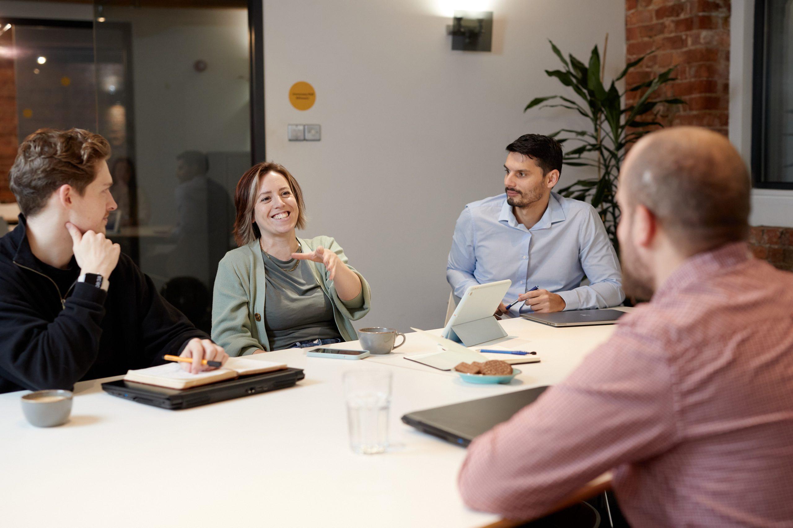 Woman talking at meeting table